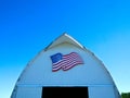 Front of white barn with American flag on Minnesota farm Royalty Free Stock Photo