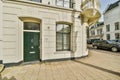 the front of a white building with a green door