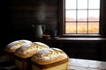 In front of a window, a table is graced by the presence of three freshly baked loaves of bread. Royalty Free Stock Photo