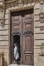 Front wooden high door in colonial building of old Havana, with beautiful ornamental carvings.