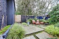 Front yard with blue fence and concrete tiles