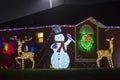 Front yard with brightly illuminated christmas decorations. Outside decor of florida family home for winter holidays Royalty Free Stock Photo