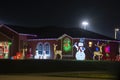 Front yard with brightly illuminated christmas decorations. Outside decor of florida family home for winter holidays Royalty Free Stock Photo