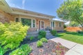 Front yard garden landscape of a fenced house with bricks