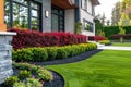 Front yard, landscape design with multicolored shrubs intersecting with bright green lawns behind the house is a modern Royalty Free Stock Photo