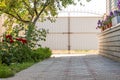 Front yard on residential home with tile path, flowers and cherry tree