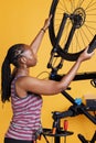 Athletic woman securing bicycle wheel