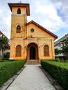 Front of yellow historic Christian church age over 100 years old