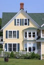 Front of a yellow house and blue sky