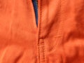 Front zipper on orange jeans