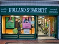 The frontage of a branch of Holland and Barrett - a British-based multinational chain of health food shops with over 1,300 stores