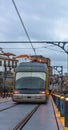 Frontal close-up of the front part of the cabin of the Porto metro train or tram approaching while traveling on the tracks over Royalty Free Stock Photo