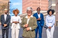 Mature businesswoman stand next to his work team outdoors