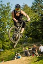 Mountainbiker jumping over a dirt jump Royalty Free Stock Photo