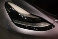 frontal view advanced xenon head-lights of Tesla car model Y in liquid silver, Mercury Silver Metallic color, popular passenger
