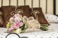 Bridal bouquet of roses on a classic bed