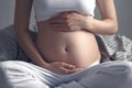 Frontal close up of pregnant woman`s bully in bed hugs bully the pace of a hero, prenatal yoga Royalty Free Stock Photo