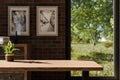 frontal view on empty clean wooden desk workplace minimalist office background with panoramic view on idyllic garden digital Royalty Free Stock Photo