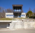 Frontal view of modern isolated villa, surrounded by nature. Iron and concrete cladding