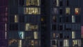 Frontal view of night facade of building with a lot of windows with light timelapse. Royalty Free Stock Photo