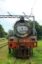 OLD STEAM LOCOMOTIVE FROM THE FRONT AT AN ABANDONED STATION Royalty Free Stock Photo