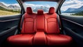 Frontal view of plush and comfortable red leather back passenger seats in a modern and luxurious car