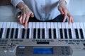 Frontal view of a woman learning to play the electronic piano Royalty Free Stock Photo