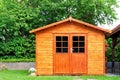 Frontal view of wooden garden shed in a summer Royalty Free Stock Photo