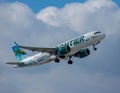 Frontier Airbus A320 flying in the cloudy sky