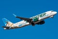 Frontier Airlines A320 N233FR airplane flying in a blue sky