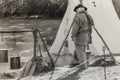 Black and white of reenactor tending to his boiling water