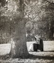 Vintage style black and white woman sunbathing in the meadow.