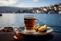 Fronting the Bosphorus Bay, a woman relishes her Turkish tea
