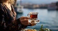 Fronting the Bosphorus Bay, a woman relishes her Turkish tea