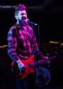 Frontman concept. Man with shouting face holds guitar, singing Royalty Free Stock Photo