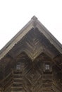 Fronton of an old wooden house. Decorated with wood carvings. Exterior details. Close-up Royalty Free Stock Photo