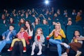 Frontview of emotional people watching film in the new cinema. Royalty Free Stock Photo