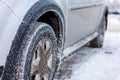 frost covered car wheel at cold winter morning Royalty Free Stock Photo