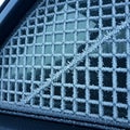 Frost-covered car window designed with a grid pattern. Each square is uniformly Royalty Free Stock Photo