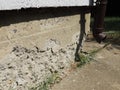 Frost-damaged concrete foundation of a building.