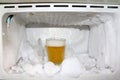 Frost and glass of beer in the fridge. Royalty Free Stock Photo