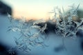 Frost pattern on window glass in winter cold blue light with orange glimpses of sunset. Christmas and New Year Royalty Free Stock Photo