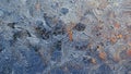 Frost pattern on window glass in winter. A tracery of magical fantastic plants. Stems and leaves from ice crystals. Dark blue Royalty Free Stock Photo