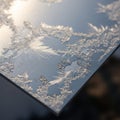 Frost patterns on a smooth reflective surface form intricate crystalline Royalty Free Stock Photo