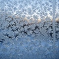 Frost patterns on a window create intricate, fern-like formations against a clear sky. Royalty Free Stock Photo