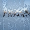 Frost patterns on a window create intricate, fern-like shapes. The translucent ice Royalty Free Stock Photo