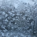 Frost patterns on a window create intricate, symmetrical designs resembling fern Royalty Free Stock Photo