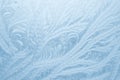 Frost patterns on window glass in winter season. Frosted Glass Texture. Blue background Royalty Free Stock Photo