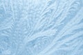 Frost patterns on window glass in winter season. Frosted Glass Texture. Blue background