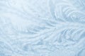 Frost patterns on window glass in winter season. Frosted Glass Texture. Blue background Royalty Free Stock Photo